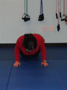 Performing push-ups with your elbows tucked into your sides works the back of arms or tricep muscles.
