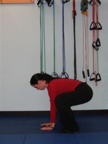 Squat down and place palms on the floor.